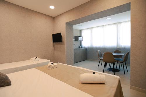 a hotel room with a bed and a dining room at Palazzo Borgo Trento - Royal Welcome in Verona