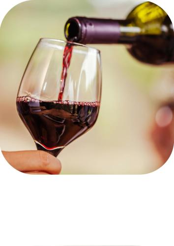 a person pouring wine into a wine glass at Far Life Hotel in Antalya