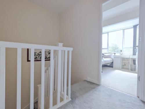 a white staircase in a white room with a window at Guest Rooms Near City Centre & Dock Free Parking in Liverpool