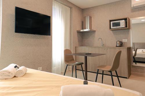 a hotel room with a bed and a table and chairs at Palazzo Borgo Trento - Royal Welcome in Verona