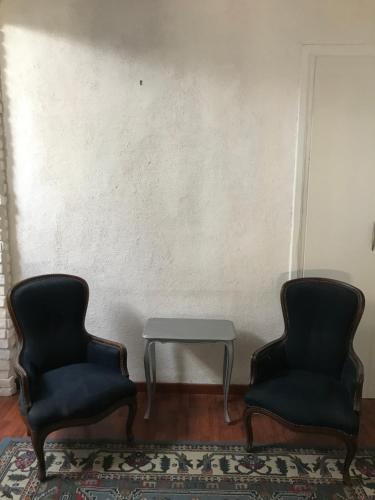 two chairs and a table in a room at LRt in Trieste
