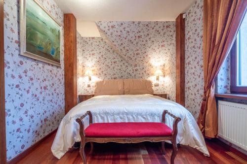 a bedroom with a bed with a red bench at Amber dream Karkle in Karklė