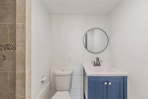 a bathroom with a toilet and a sink and a mirror at Luxury and Cute Home in Irving 4 bedrooms,5 beds in Irving