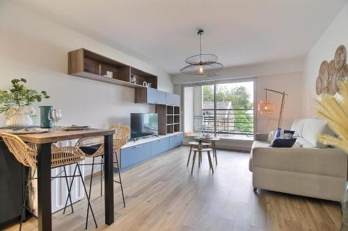 a kitchen and living room with a table and chairs at L'Universel in Vannes