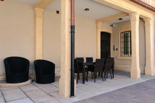 a dining room with black chairs and a table at Palazzo Borgo Trento - Royal Welcome in Verona