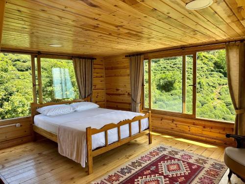 a bedroom with a bed in a wooden cabin at NaylaKonak in Cayeli