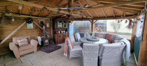 a living room with a table and chairs in a caravan at Merrifield House Devon in Kingsbridge