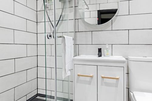 a bathroom with a shower and a sink and a mirror at Hidden retreat in the heart of the city - 2 Bed Apt in Nottingham