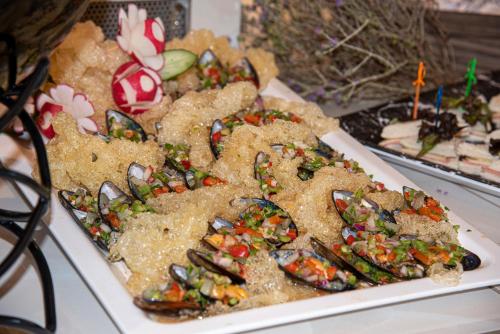 a plate of food on top of a table at Vantaris Luxury Beach Resort in Georgioupolis