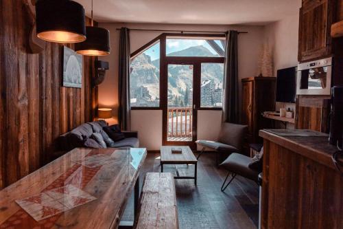 a living room with a table and a large window at IMMODREAMS - Chalet Le Grand Paradis - Avoriaz in Avoriaz