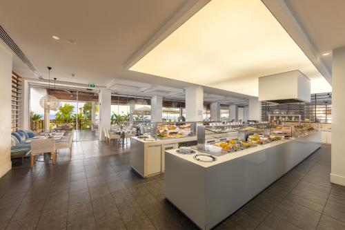 a restaurant with a buffet line of food at Capo Bay Hotel in Protaras