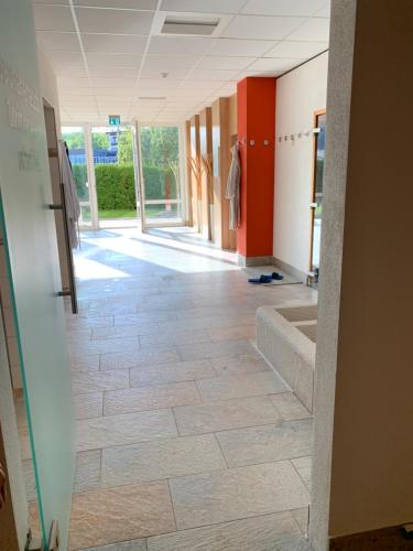 a hallway of a hospital with a tile floor at FeWo Längl -Waldluft- mit Pool und Sauna im Allgäu in Scheidegg