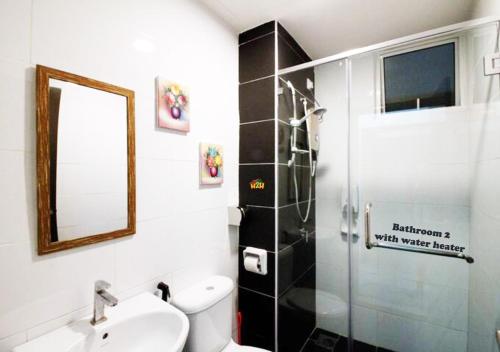 a bathroom with a shower and a toilet and a sink at H2H - Holland Cottage - Majestic Ipoh - 7pax in Ipoh