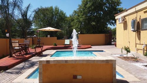 a fountain in the middle of a patio at SteyMorr Guesthouse in Maun