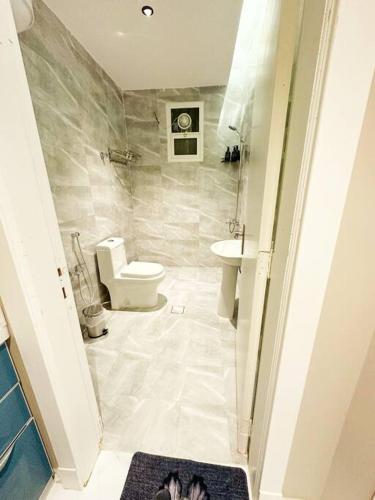 a bathroom with a toilet and a sink at Elegant and luxurious one bedroom studio, side entrance 1D in Riyadh