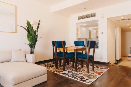 a living room with a table and chairs at LOFTS by Elegant Hospitality in Cairo