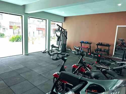 a gym with bikes parked in a room at Benteh Aqua View in Banjul