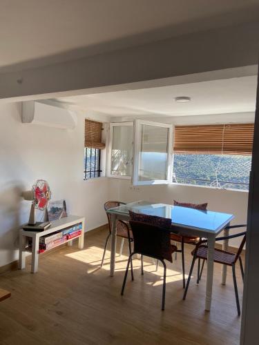 a dining room with a blue table and chairs at La casilla de Vicente in Torres