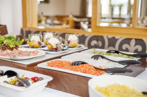 a table with many plates of food on it at Gasthof Adler in Bad Wurzach
