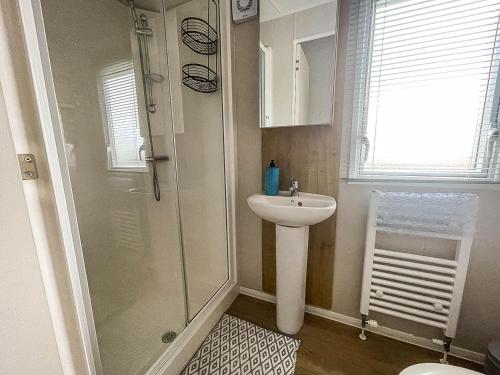 a bathroom with a shower and a sink at Beautiful 6 Berth Caravan With Decking In Norfolk Ref 89001mv in Belton