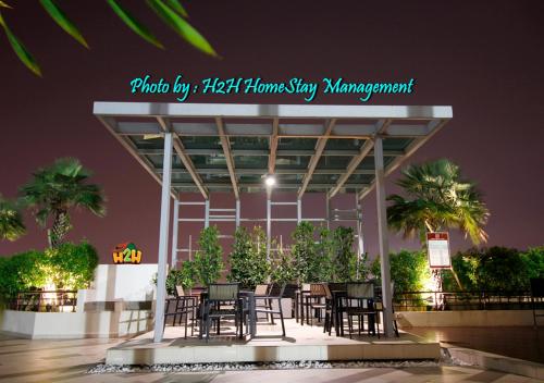 a group of tables and chairs under a building at H2H - Holland Cottage - Majestic Ipoh - 7pax in Ipoh