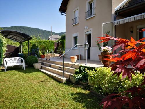 a backyard of a house with a bench and some plants at Le Mimat - Jardin - Wifi - Parking in Mende