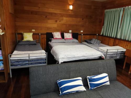 Voodi või voodid majutusasutuse Formosa Backpackers Hostel & Apartment（青年民宿） toas