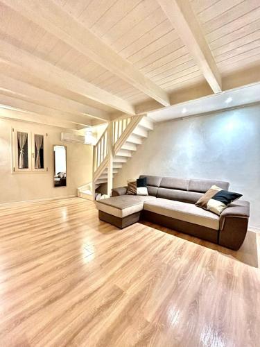 a living room with a couch and a staircase at Il Maniero casa vacanze by MOH in Grottaglie