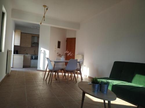 a living room with a table and chairs and a couch at Anna's Cozy Flat in Lefkada