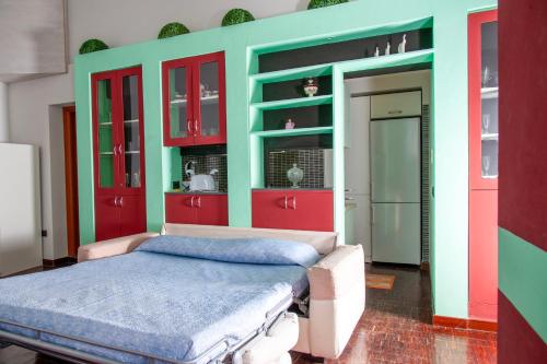 ナポリにあるPalazzo Carafa della Spina - Maison de Charmeの赤と緑のキャビネットとベッドが備わるベッドルーム1室