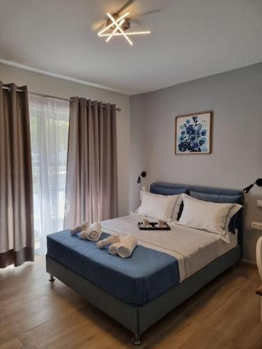 a bedroom with a large bed with towels on it at Harmony in everything in Athens