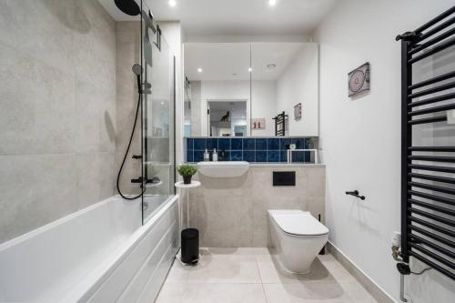 a bathroom with a toilet and a sink and a shower at Peachy Stays 2-Bedroom Amazing Flat With Balcony in London