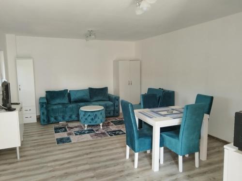 a living room with a table and chairs and a couch at Stari Hrast 1 in Prolomska Banja