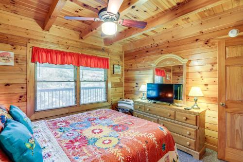 1 dormitorio con 1 cama y TV de pantalla plana en Sevierville Cabin with Deck, Pool and Lake Access!, en Sevierville