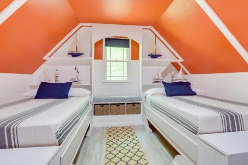 two beds in a attic room with orange walls at Pet-Friendly Cropwell Retreat on Coosa River! 