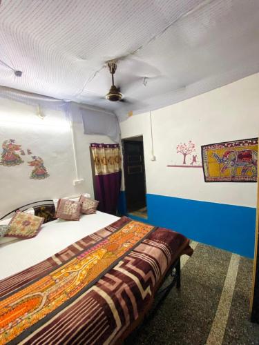 a bedroom with a bed in a room at Mirvana Guest House & Camel safari in Jaisalmer