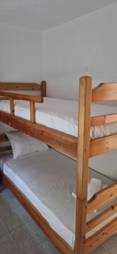 two wooden bunk beds in a room at Pefkochori Family Spot in Pefkohori