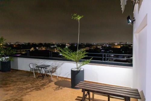 a plant on the ledge of a balcony at night at Impeccable 1-Bedroom Furnished Apartment in Accra in Accra