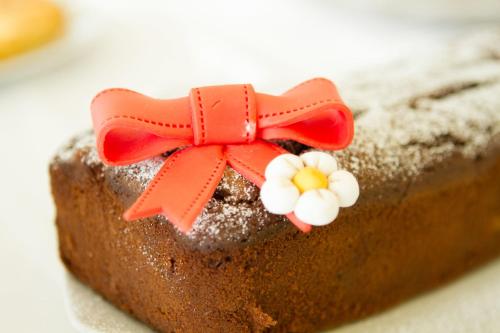 a piece of cake with a red bow on it at Hotel Nord Est in Rimini