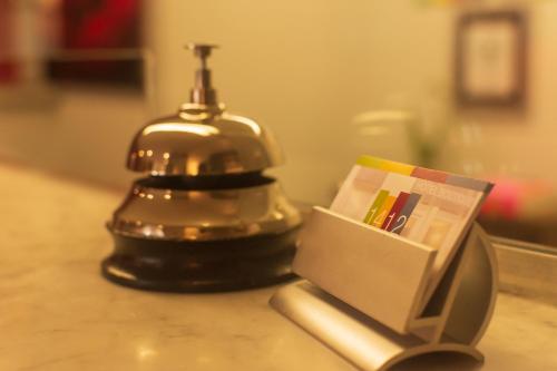 a bell sitting on a table with a box on it at 1412 Hotel Boutique in Rosario