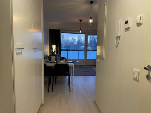 a room with a table and a dining room with a window at Kaksio keskustassa ja rannan läheisyydessä in Hämeenlinna