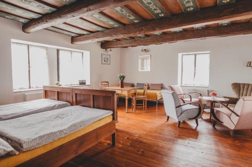 a bedroom with a bed and a dining room at Boutique Apartmán Speicher in Prague