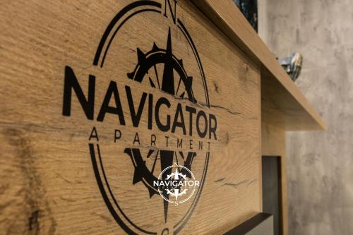 a wooden sign for a napierarma department on a building at Navigator Apartment in Bijeljina