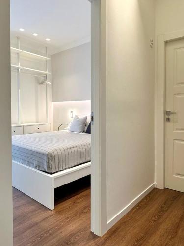 a white bedroom with a bed and a closet at Iblu Rooms in Termoli