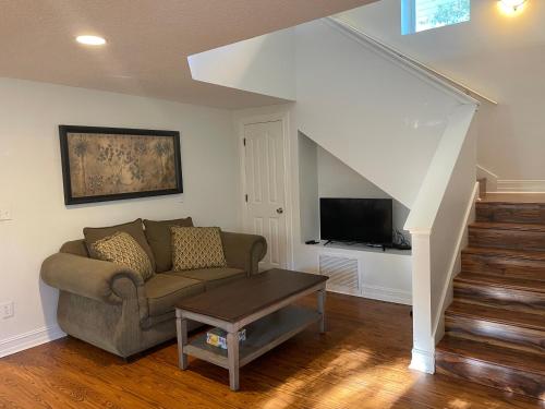 a living room with a couch and a tv at Spacious renovated 4br downtown home w firepit sleeps 8+ in St. Augustine