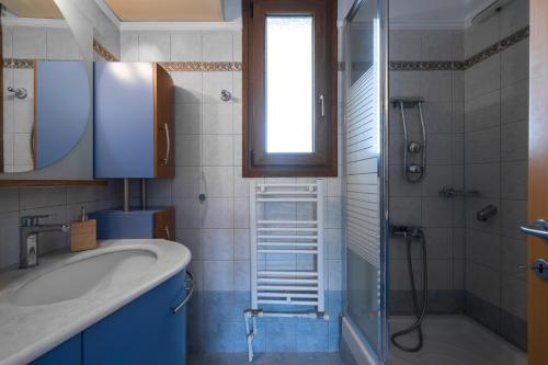 a bathroom with a sink and a shower at Afytos Wonder View by Luxlikehome in Afitos
