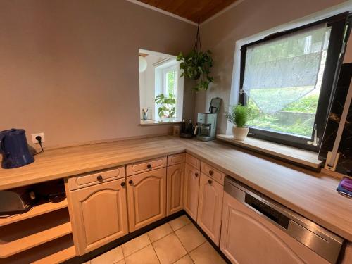 a kitchen with a wooden counter and a window at FeWo Kaiserblick in Treuchtlingen