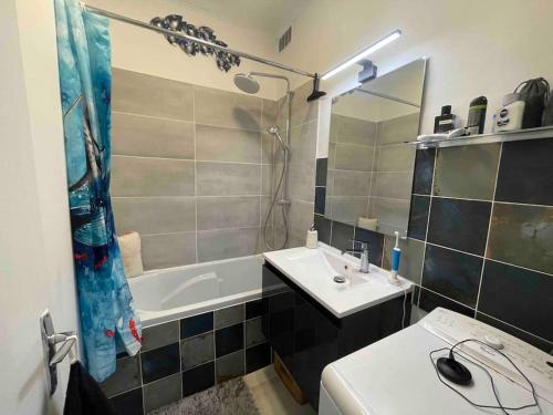 une salle de bain avec un lavabo, une douche et une baignoire dans l'établissement L'authentique vie parisienne, à Paris