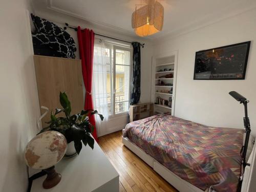 une chambre avec un lit et une fenêtre dans l'établissement L'authentique vie parisienne, à Paris