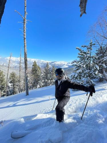 a person on skis standing in the snow at Hotel Or Blanc in Espot